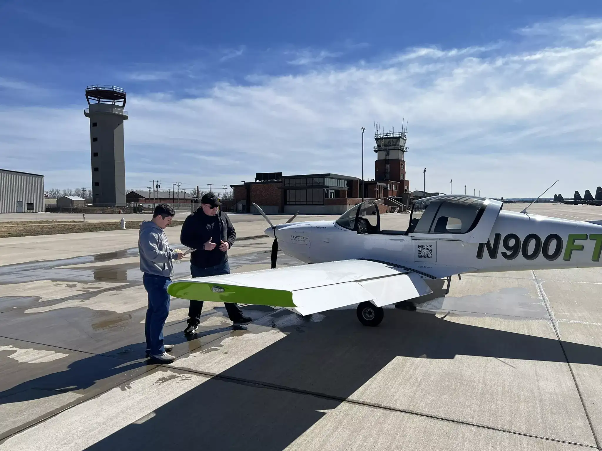FlyTech Pilot Academy aircraft parked on runway at sunset