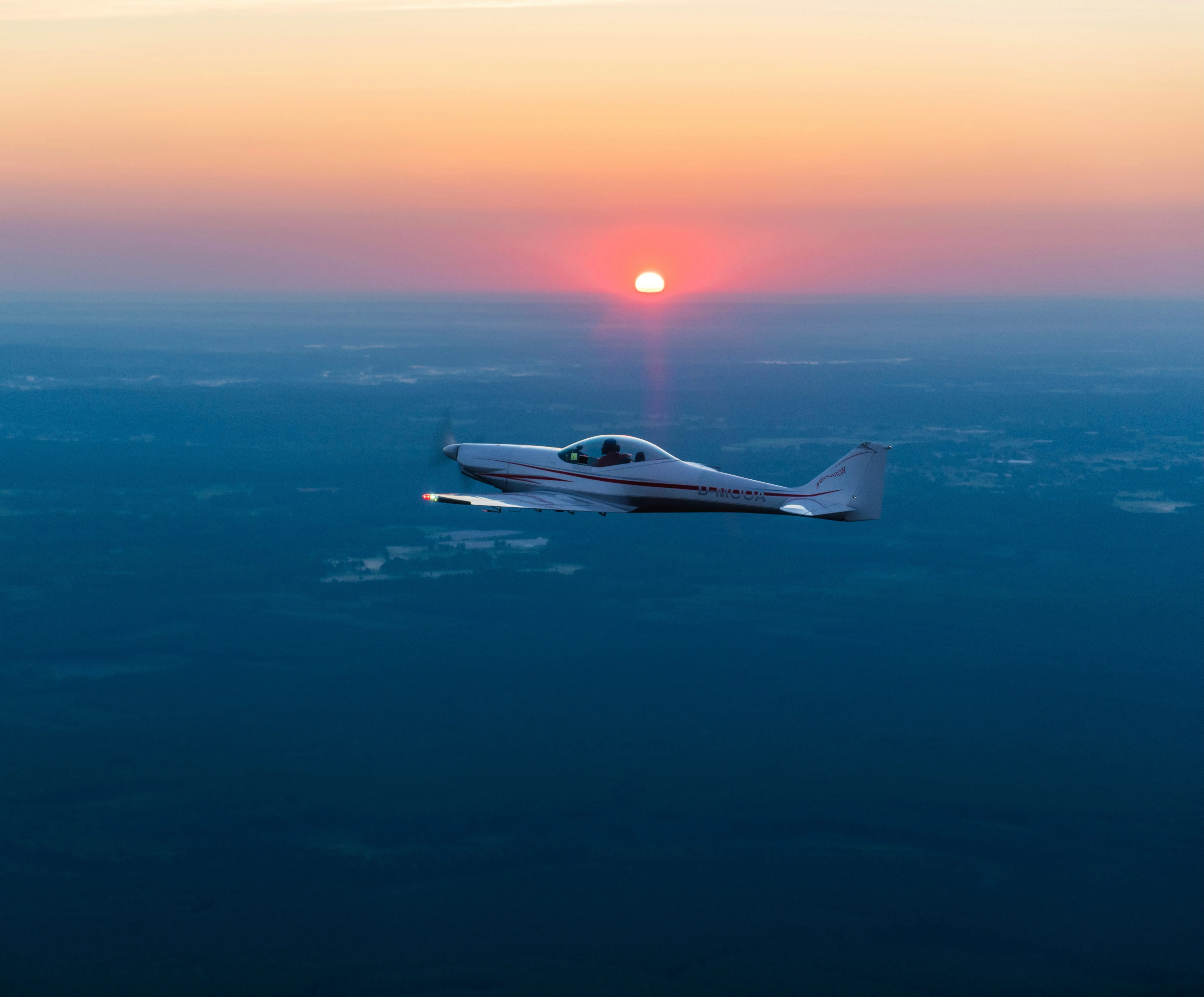 Smiling pilot holding headset in cockpit