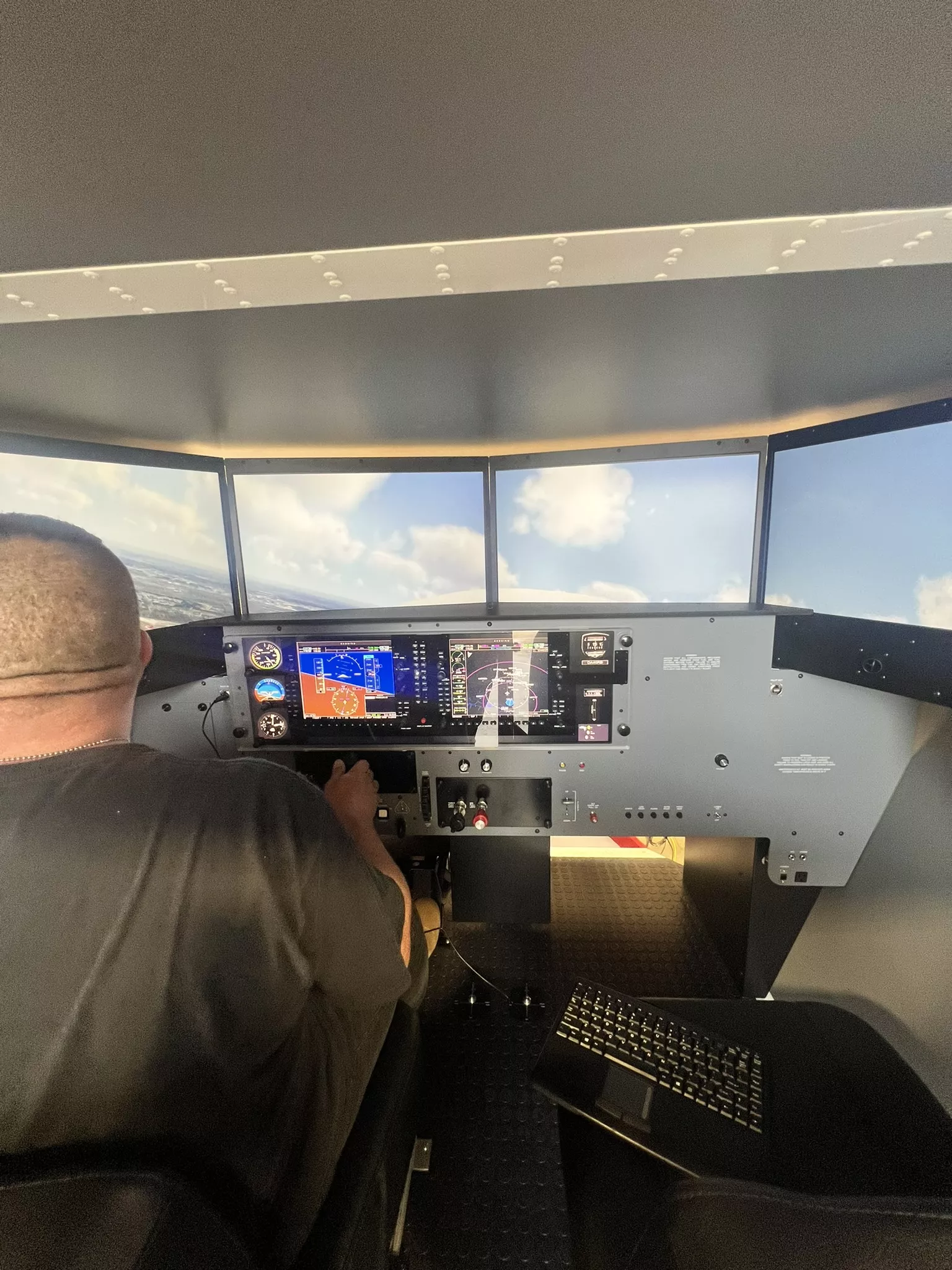 Student pilot practicing flight maneuvers in a full-motion simulator