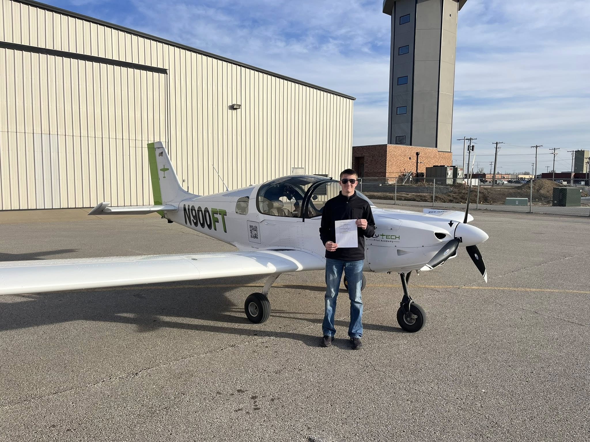 Student pilot holding a new pilot certificate
