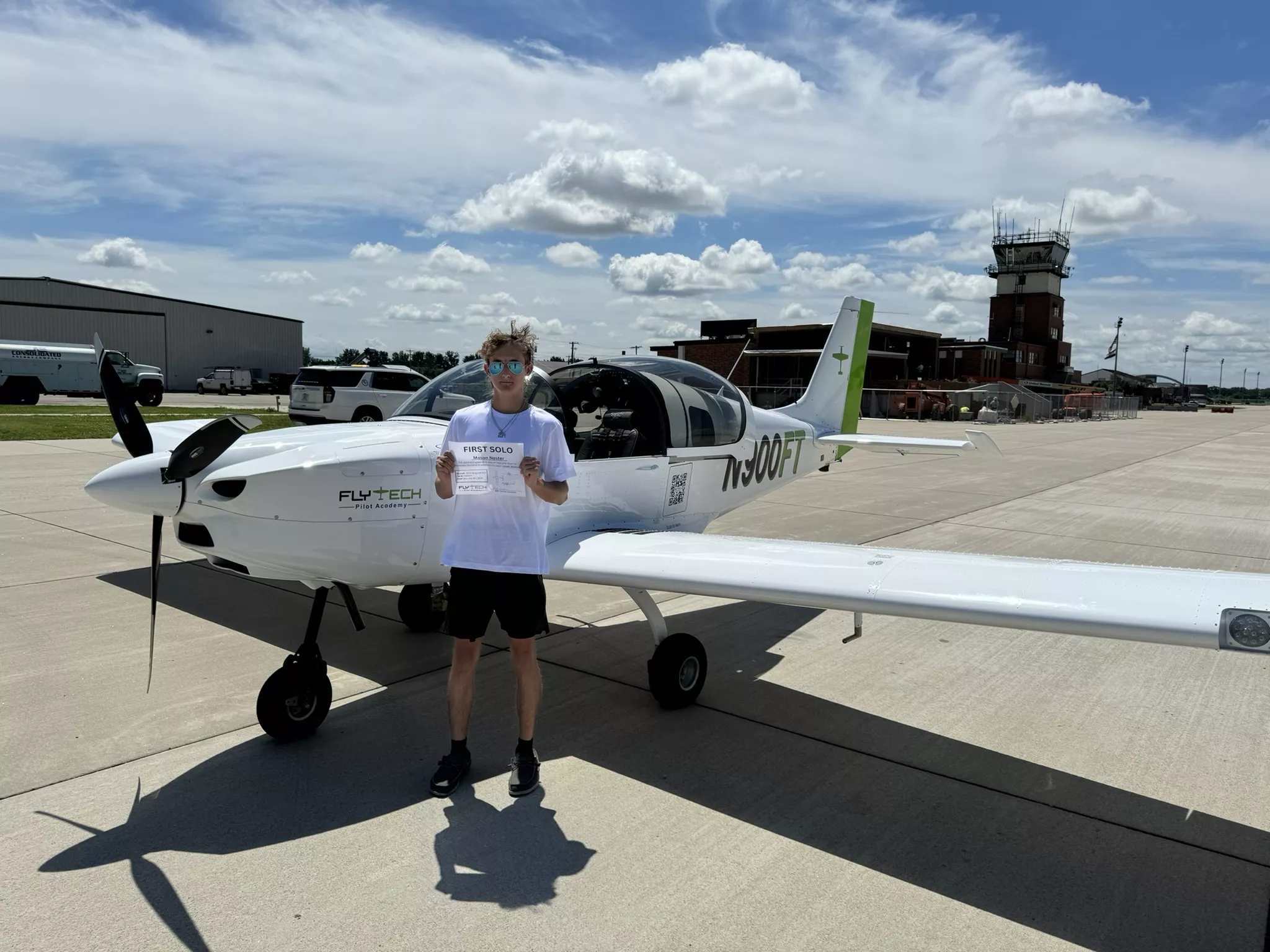 Student pilot holding a pilot certificate after finishing a training stage